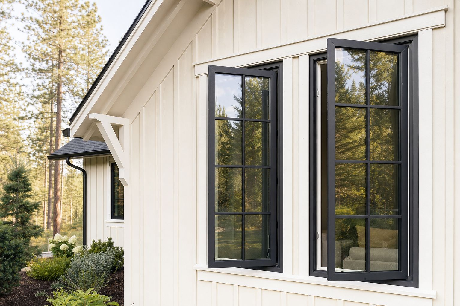 New black-framed casement windows on a cream farmhouse wall