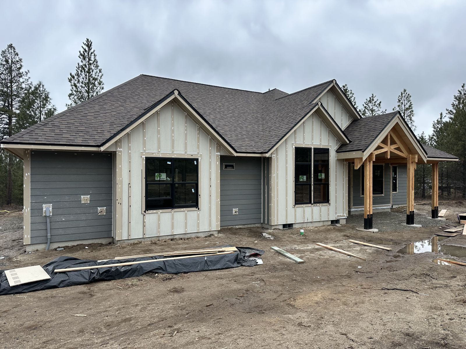 New ranch home with timber entry and board-and-batten siding near Cheney