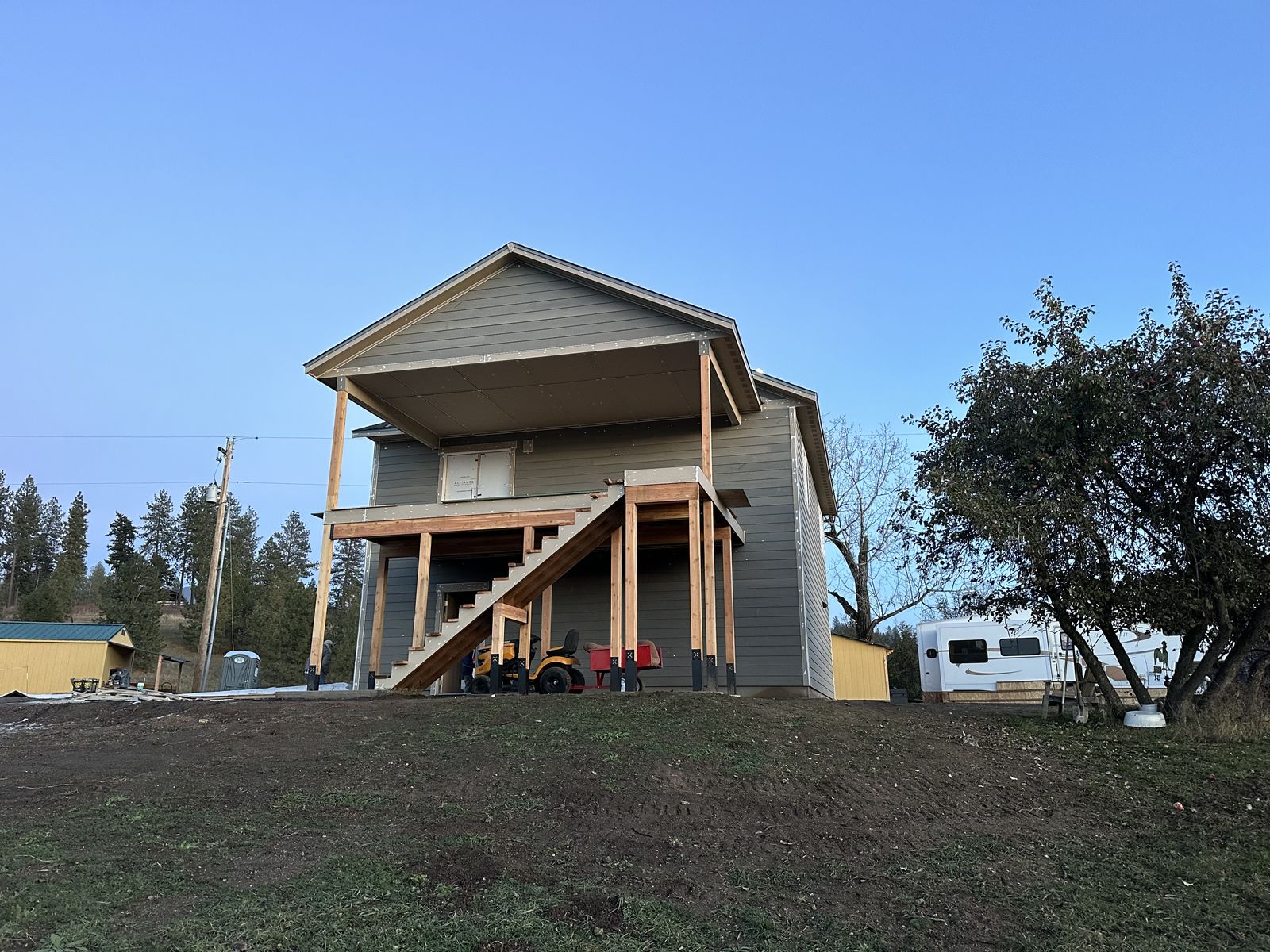 Elevated deck on timber posts at a hillside home near Mica